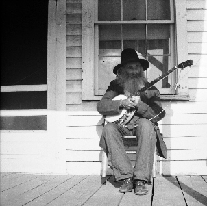 Monroe Caudill playing banjo
James Monroe Caudill-born 28 April 1877-died 26feb 1957 to Cynthia Ann Caudill. His father was Richard "Dick" Sidden of Wilkes County who later (Monroe was in his twenties) married Cynthia. Monroe married Myrtle Jane Rector the daughter of Abe and Martha Brackins, Rector. Ther had three children, Emma , Carpenter, Mary Ann Todd and Johnny Caudill who married my aunt Rose Emma Medley. Monroe would sit on the porch of his house at "Teapot Dome" Alleghany County, NC and play his banjo for passers by.  Courtesy
