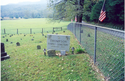 Thompson_Cemetery__1.jpg
Description: Ann Combs, Beam a descendant of the Thompson family of Surry County, North Carolina came down from Alexandria, Virginia in October of 2003. She and her husband came by to see me for a few minutes and then went by Devotion. The gatekeeper of the Reynolds estate allowed them to go inside to the Thompson cemetery. 
Directions from the gate to the Thompson Homestead and Graveyard site:Get Permission at the gatehouse
Go through gate for 3 10ths miles on right, inside fence. Mitchell's River and the creek flow on either side. 
Buried here are Martha Thompson wife of Hiram Higgins. (Hiram was killed in the Civil War and Martha was murdered by John Jack Mayes and burned in her house ) The cemetery is being kept in very good condition.  Courtesy of Nanalee Wrenn [email]nwrenn37@yadtel.net[/email]
