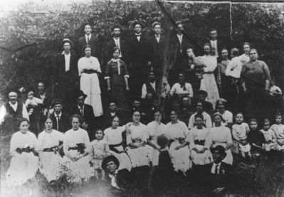 Weaver, Clayborn Monroe Family
this 1915 image was made at the wedding of Isaac Quincy QWeaver and Amanda Perkins, who are not pictured.  Clayborn Monroe Weaver is on the extreme left and his wife Martha Lititicia Phupps Weaver is on the extreme right of the photo.  from Jeff Weaer's collection.
