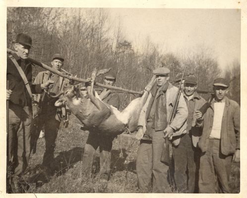 CBdeerhunting.jpg
My grandfather was born in 1889 and in this picture he looks to be in his 40s at most, so I guess this scene was in the 1930s, and though he had lived in Maryland since 1920, this hunting party probably was "back home" because his brother Dent and, according to an aunt, his nephew Glenn Kilby, both Ashe Countians, are in the picture. I send this, thinking you might recognize the other hunters. To identify those I know:   at deer's hindquarters with gun over shoulder--Charles Bradley Pennington, second from right, Dent Pennington; far right, Glenn Kilby.  Courtesy of Emily Kilby [email]erk44@verizon.net[/email]
