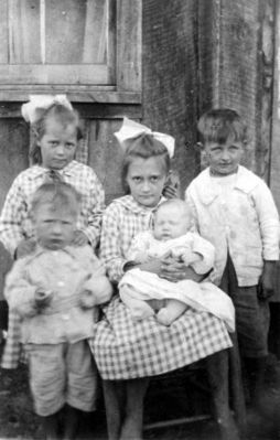 Daddyboy.jpg
This photo is of my father Ira Johnson and his siblings, taken probrably in early 20's. From left to right: Florence is standing with her hands on John's shoulders. Juanita, seated, is holding baby Melvin and Daddy (Ira) is holding on to the chair. Daddy almost always wore that little grin and a light in his eyes.  Courtesy of Lesa Long [email]ladygwenhwyvar@hotmail.com[/email]

