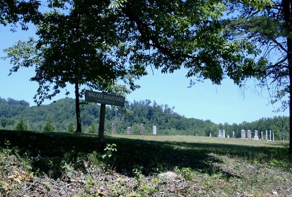 Haystack Road
The sign on the side of the road and the graves in the background.   You can see what a great job someone has done to clean up and maintain the place. 

Date Taken: 6/22/02 

Place Taken: Haystack Road near Devotion in Surry County, NC

Courtesy of Nanalee Wrenn
