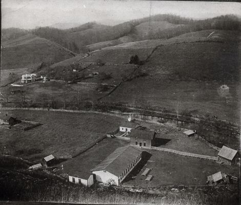 Littlewoodproperty1900a.jpg
This picture was probably taken between 1900 and 1905. The mill, built around the turn of the century to replace the burned mill belonging to the Perkins family, was bought by John Littlewood, an immigrant from 
Yorkshire, England. In about 1900 his son Herbert Littlewood joined his  father in the business. The mill is the long building at the center  bottom. The two story building facing it was a general store. The two 
cottages were the Littlewoods' residences. The Victorian house upper left was the Perkins's home.
Courtesy of Emily Kilby [email]erk44@verizon.net[/email]

