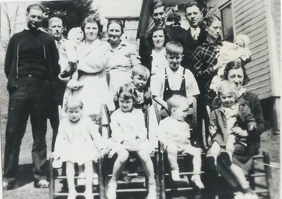 WadeandDentonJonesfamily.jpg
first row (l to r): Freda Jones, Mary Jones (my mother), Phil Stanley, Irene Jones Weaver holding Patsy Jones.  2 boys behind chairs: Lloyd Dean Jones, J. B. Jones. back row standing (l to r) Wade Jones Jr. 9my grandfather), Della Yates Jones (my grandmother) holding Bobby Jones, Denton Young Jones (my great-grandmother), Emma jones Stanley, behind her Virgil Stanley, peeking from behind Virgil is Elmo Jones, beside Virgil is Gilmer Jones, Ruth Jones holding son Tom Jones.  Courtesy of Danny Miller [email]millerd@fuse.net[/email]

