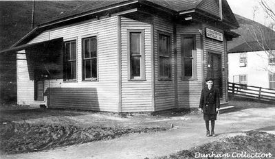 Salrville - Post Office and Harry Dunham
HARRY S. DUNHAM OF SALTVILLE, VA.  AT AGE 12...STANDING IN FRONT OF SALTVILLE'S THIRD POST OFFICE IN 1918.  THIS POST OFFICE WAS BUILT ABOUT WHERE CARLTON CHAPMAN'S FIRST CHOICE FLOWER SHOP IS PRESENTLY LOCATED.  HARRY WAS BORN DEC. 4, 1906 AND DIED ON JAN. 8, 2001 AT THE AGE OF 94.
 
THE FIRST POST OFFICE WAS LOCATED IN THE "OLD STORE" AT THE LOWER END OF SMOKEY ROW.  THE SECOND POST OFFICE WAS IN THE MATHIESON GENERAL STORE NEAR THE MEAT MARKET.  THE FOURTH ONE WAS MOVED A COUPLE OF DOORS UP THE STREET FROM THE ONE PICTURED.  FROM THERE, POST OFFICE NUMBER FIVE WAS LOCATED IN A BUILDING WITH THE BOWLING ALLEY, JAIL  AND POLICE STATION.
 
NUMBER SIX WAS BUILT IN 1931 AND WAS USED UNTIL 1966.  THIS BUILDING CURRENTLY HOUSES THE SALTVILLE LIBRARY.
 
IN 1966, THE PRESENT DAY POST OFFICE WAS OPENED FOR BUSINESS.  Coirtesy of Don Smith [email]dsmith1043@cmcast.net[/email]
 
