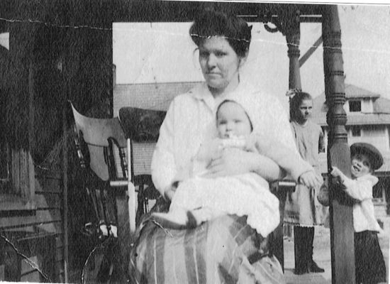 Hash, Nancy
The adult is NANCY RETTI COLUMBIA HASH m. James Thomas Hash.  Baby is William Boughner  son of Polly Jane Hash Boughner.  Young boy leaning on pole is James Robert Hash b: Aug. 4,1910 Bourbon Co. Ky
Young girl is Rosey Hash Coleman   Courtesy of Barbara Lepsik [email]lepsik@comcast.net[/email]
