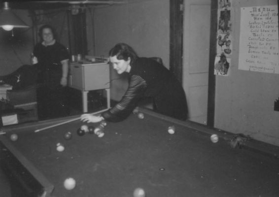 poolhall1.jpg
This 1938 John Porter shows a woman playing a game of pool.
