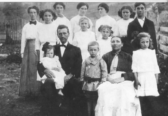 Kilby, Roby
Roby and Eva Osborne Kilby with 12 of their 15 children taken in 1911/12 in the Sturgills area of Ashe County, NC. The oldest was born in 1890 and the youngest pictured in 1910. [L-R, top row with married names in parentheses] Jenny (Young), Ollie (Weaver), Emaline (Duncan), Virgie (Norman), Minnie (Sturgill)  [middle row] Lola (Sewell), Elsie (McCommons), Ruth (Umbarger), Dewey Kilby [bottom row] Lucy (Stewart) on lap of James Roby Kilby (son of Thornton Kilby and Phebe Marilda Weaver) Thornton Kilby, Ruth Eva Kilby  (daughter of Wiley Winton Osborne and Lavina Jane Mink), Mary (Eppers).  Courtesy of Emily Kilby.  [email]erk44@verizon.net[/email].
